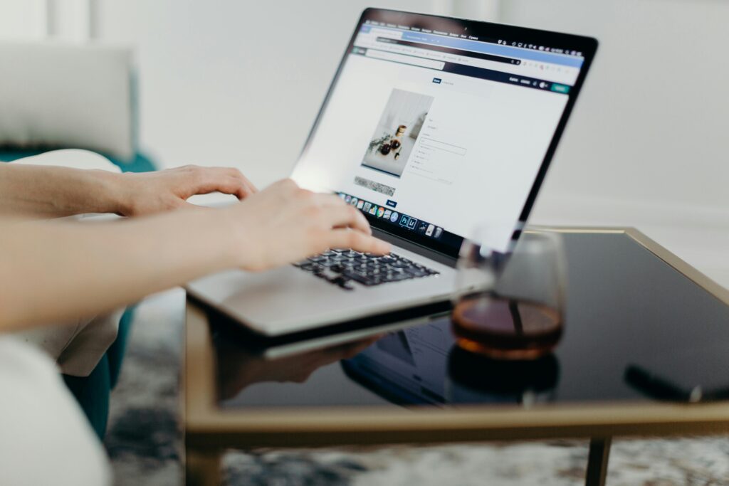 Person using macbook laptop blogging